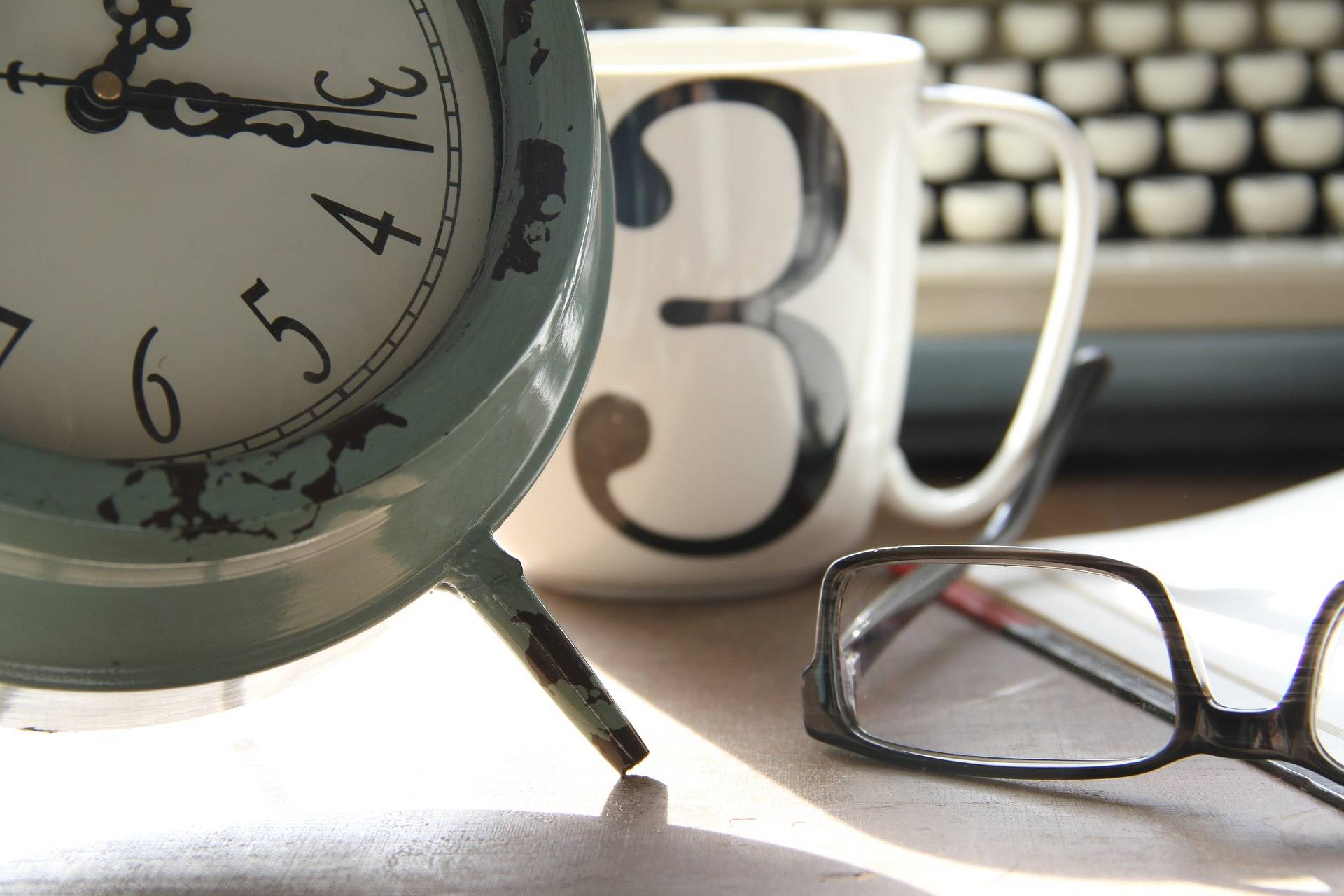 coffee cup with glasses and clock